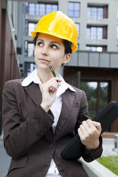 Female construction engineer and yellow helmet