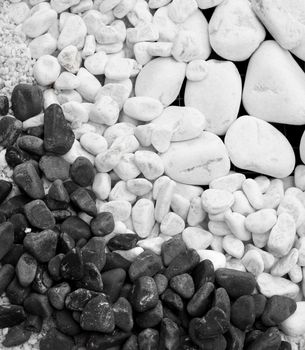 White and black round pebble stones gravel background