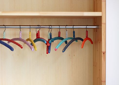 Colorful clothes hangers in porch closet