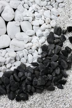 White and black round pebble stones and gravel background