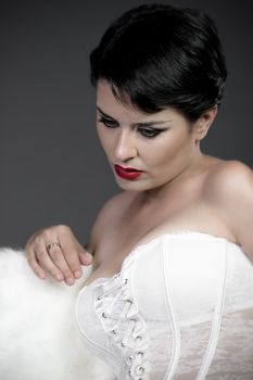 Beautiful sad bride with white corset, underwear
