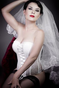 Beautiful bride with veil and white corset, underwear