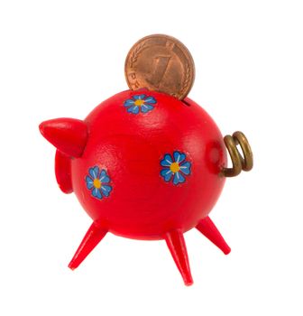 Red wooden piggybank isolated on white background. Saving money for black day in pig money-box. Nest-egg. Pfennig.
