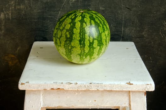 Watermelon healthy food nutrition on white painted old dirty wooden table.