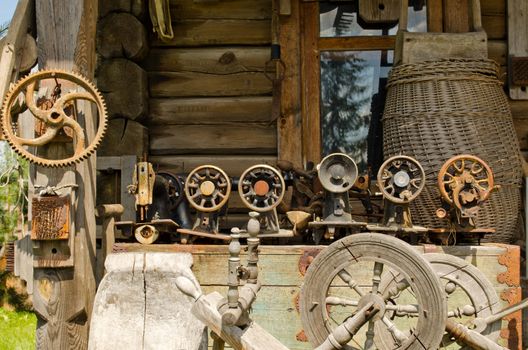 Old sewing and weaving machines equipment tools to the old rural log house