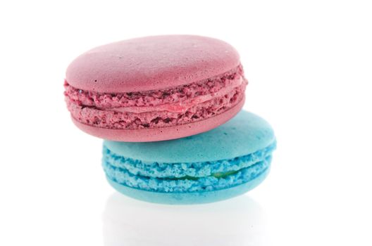 close up French macaroons in turquoise and violet on white