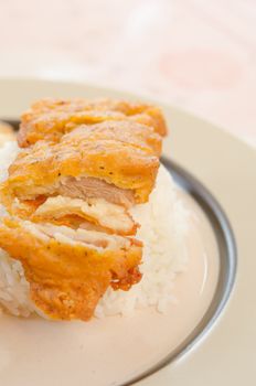 fresh  fried Chicken over steamed rice on plate