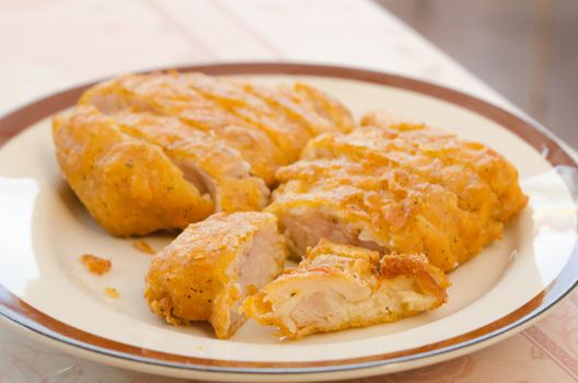  fresh fried Chicken meal  on a brown plate .