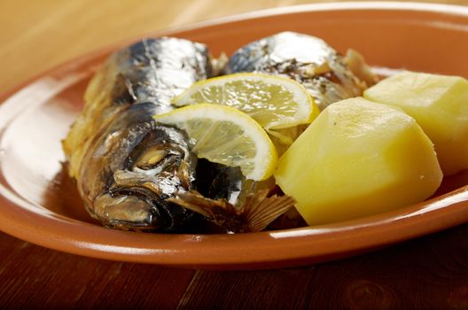 Mackerel on a grill. Fish prepared  with vegetables
