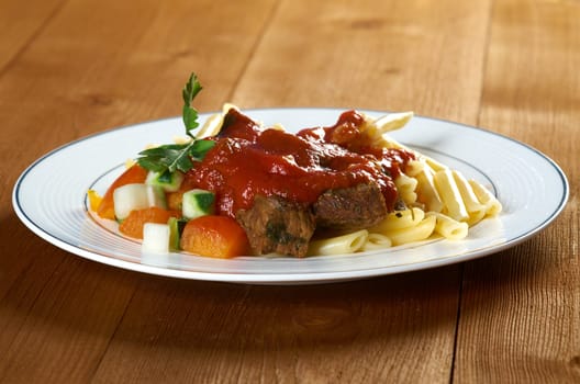  pasta with tomato beef sauce  on wooden table