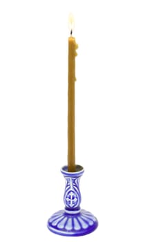 Candle on a dark blue candlestick  isolated on the white