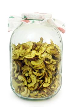 Dried apples are stored in a glass jar