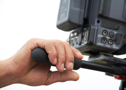 Aged hand is holding camera for shooting, filming.