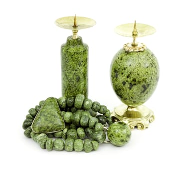 Candle holders, necklaces and a brooch made of stone serpentine  isolated on white