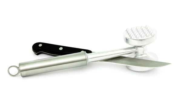 Mallet  beating the meat and a kitchen knife a steel
