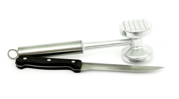 mallet  beating the meat and a kitchen knife a steel