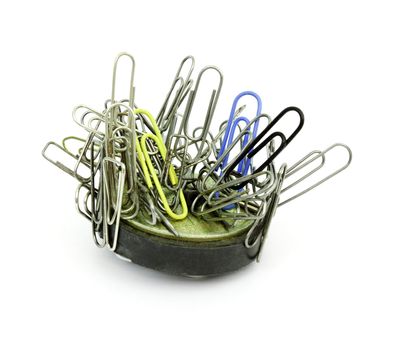 Paper clips and  magnet is isolated on a white