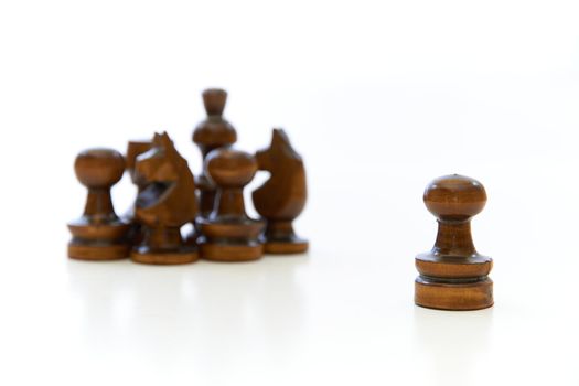 Chess pieces (pawn, knight, king) with the pawns leadership on white background