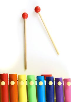 Colorful, Wooden Xylophone with Mallet Over White Background