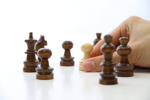 Hand taking chess piece pawn on white background