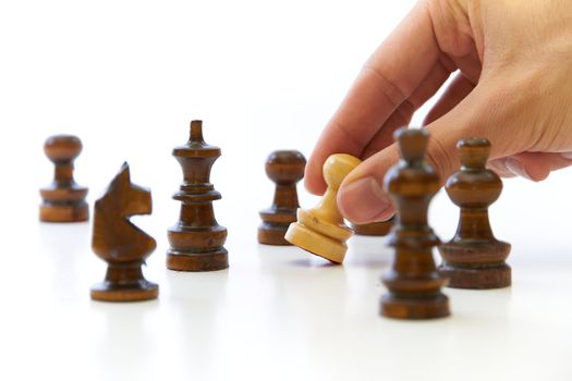 Hand taking chess piece pawn on white background