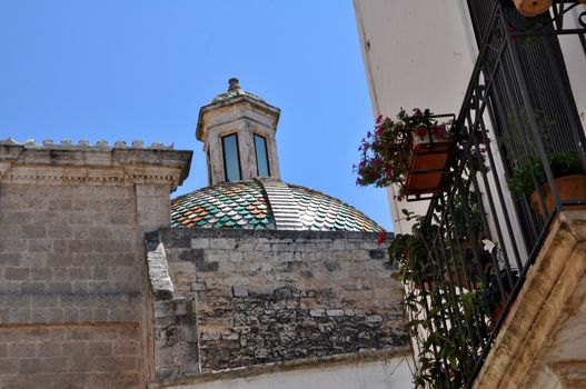 Ostuni lane in the Old Town (the White City) with a dome in the background, Puglia, Italy