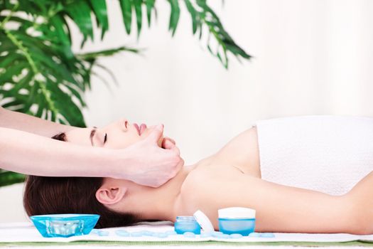 Lady in spa salon having a facial massage