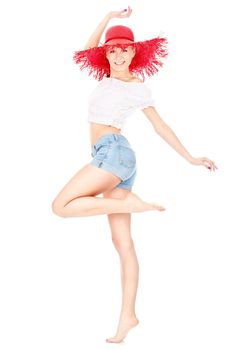 Happy young woman with big red hat barefoot dancing, isolated on white background