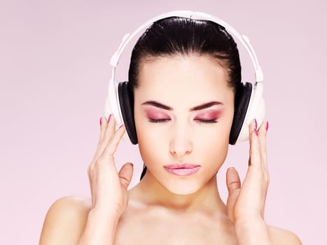 Pretty woman with headphones listening music