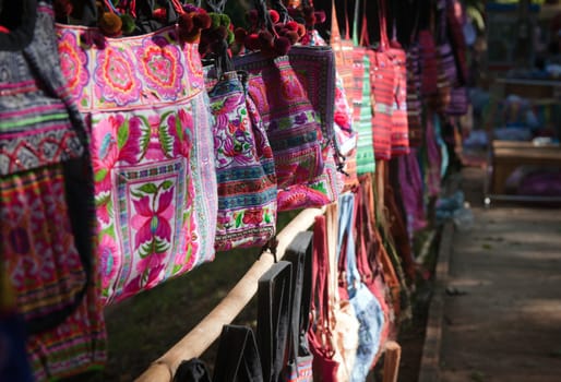 colourful bags hanging in a row for sale