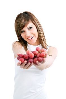 Young healthy attractive woman holding red grapes.Isolated