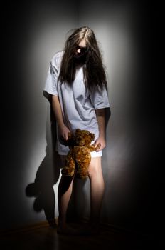 Young zombie girl with teddy bear