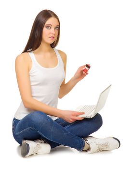 Young girl with laptop and credit card isolated