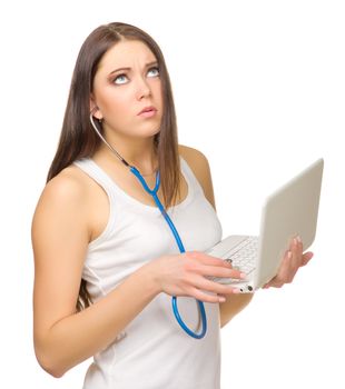 Young girl listen laptop by stethoscope isolated