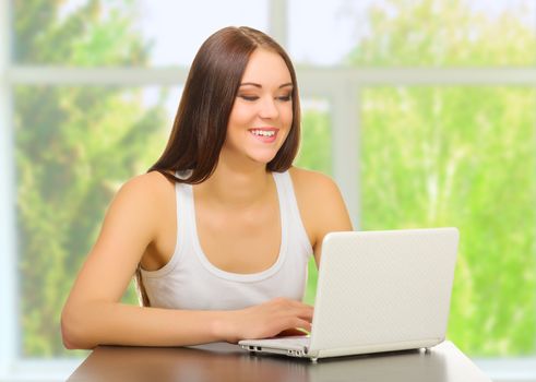 Young girl with laptop at home