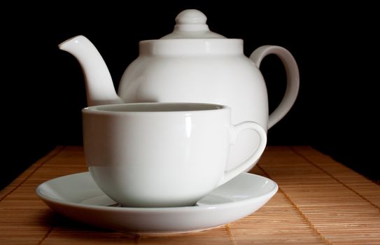 Cup and teapot on bamboo napkin