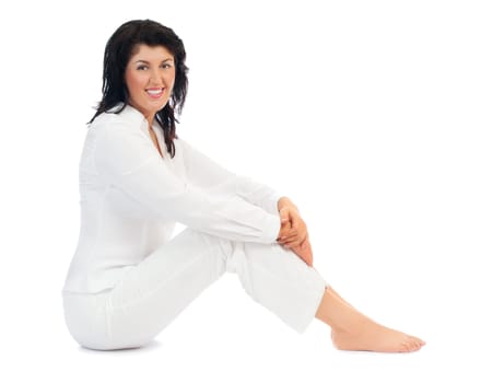 Young smiling woman sitting on floor isolated