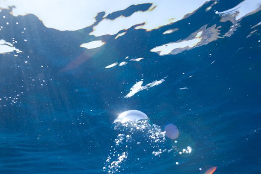 background of sunlight bubbles in deep water