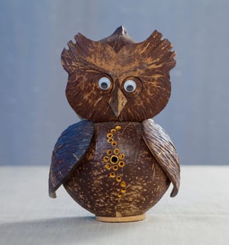 Old wooden carved Owl on table background