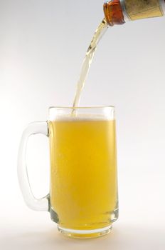 bottle and glass of beer on white background