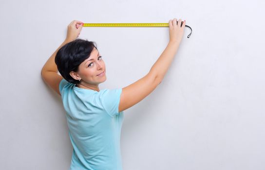 Young woman with measurement tape