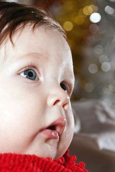 Close-up portrait of a young boy on bokeh background.