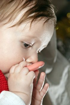 Portrait of a young baby playing with toys.