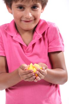 Little boy holding pieces of fruit