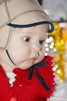 Close-up portrait of a young boy in cap.