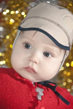 Close-up portrait of a young boy in cap.