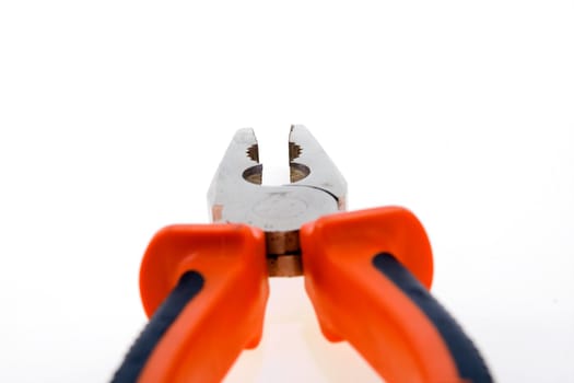 Steel used pliers with plastic color handles on a white background