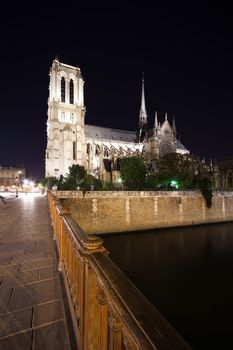 a wide-angle view of Notre Dame Cathedral at night