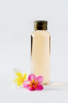  bottles and  fresh plumeria on white background