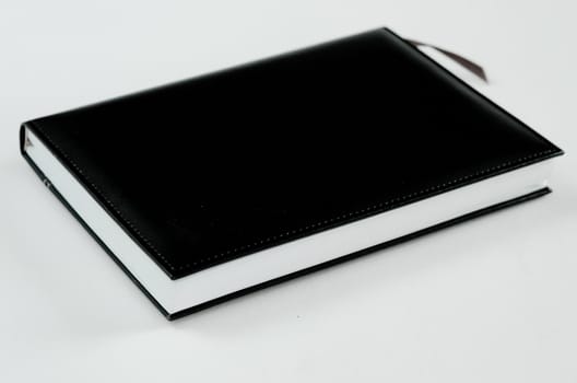 black note book and white paper on white background